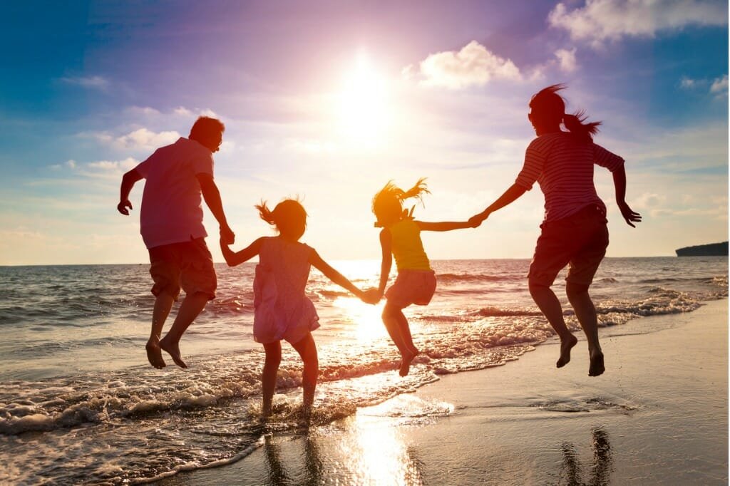 happy family jumping together on the beach picture id478165660
